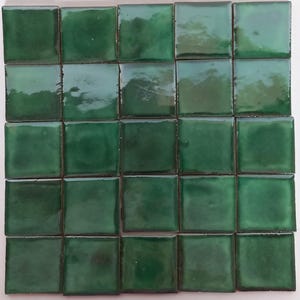 May include: A set of 25 green ceramic tiles, arranged in a 5x5 grid.