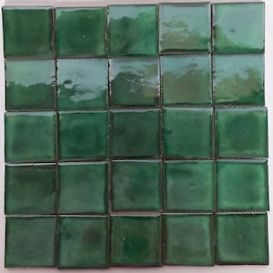 May include: A set of 25 green ceramic tiles, arranged in a 5x5 grid.