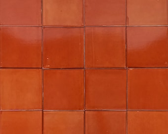 May include: A wall covered in 15 square terracotta tiles.