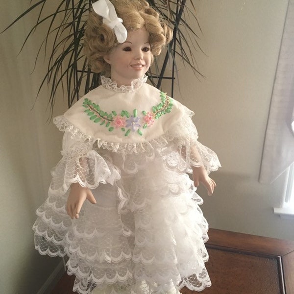 27" Shirley Temple Doll, porcelain, lovely vintage in white ruffled dress