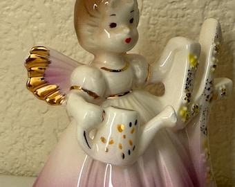 Josef Originals 4th birthday angel figurine with wings, holding a watering can.