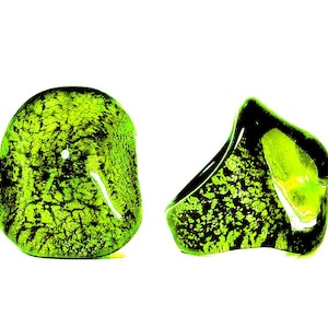 May include: Two decorative glass objects with a vibrant green and black mottled pattern. One is a rounded, rectangular shape, and the other is a curved, asymmetrical design. The objects have a glossy finish and are set against a white background.