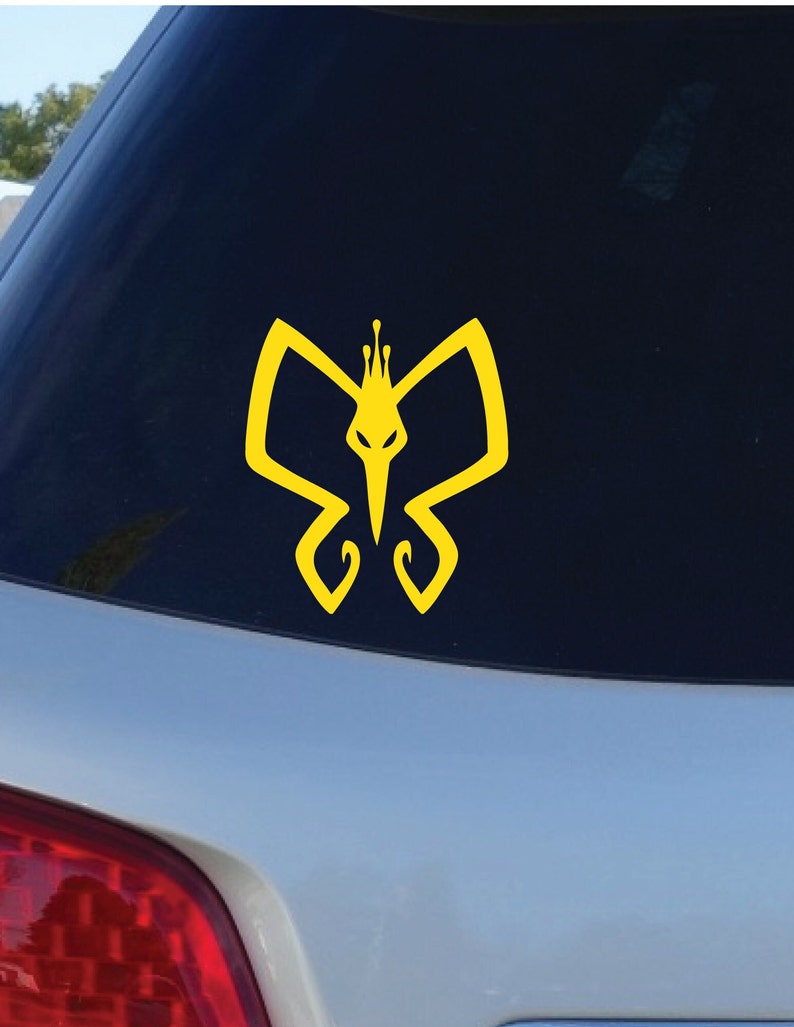 May include: Yellow vinyl decal of a stylized butterfly with a crown on its head. The butterfly has a sharp, pointed beak.