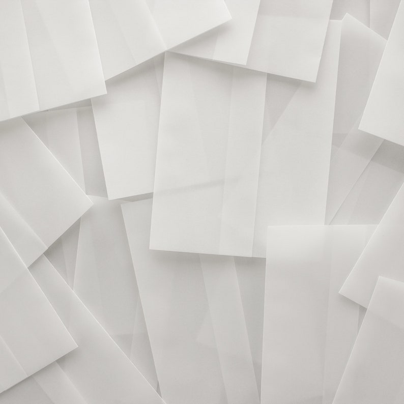 May include: A stack of white envelopes, overlapping and creating a textured background.