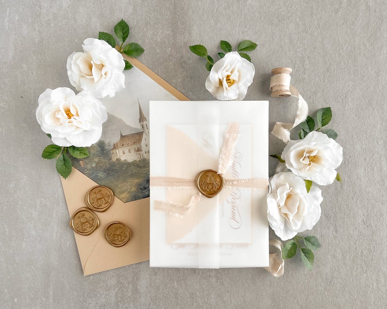 May include: A white envelope with a wax seal and a pink ribbon. The envelope is on a light gray surface with white roses and a spool of ribbon.