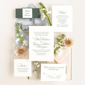 May include: Wedding invitation suite with a floral theme. The invitation features a white card with black calligraphy text that reads "Flora Christine to Quinn Jackson Harrington." The RSVP card features the text "The favour of a response is requested by the third of May."