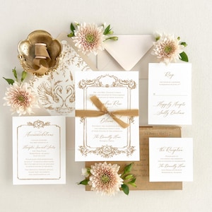 May include: Wedding invitation suite with a gold and white color scheme. The invitation features a decorative frame with a swan design. The RSVP card includes the text "Happily Accept" and the reception card includes the text "The Reception".