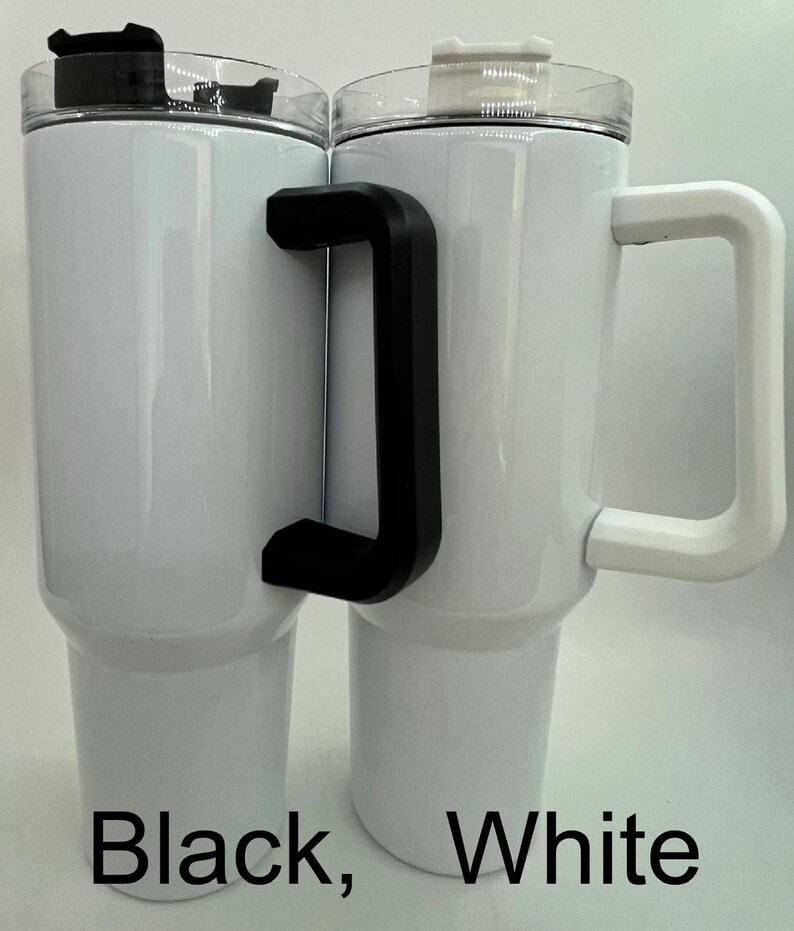 May include: Two white insulated tumblers with black and white handles. The tumblers have clear lids and the words "Black, White" are printed at the bottom. These tumblers are designed to keep beverages hot or cold for extended periods.