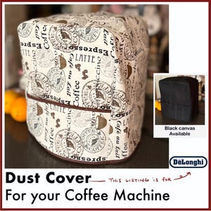 May include: A beige fabric dust cover for a coffee machine featuring a repeating pattern of coffee-related text including Espresso, Latte, and Cappuccino, along with coffee bean and cup illustrations. A brown trim accents the front pocket.