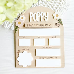 First/Last day of school sign with acrylic flowers and engraved butterflies. Features child's name in choice of acrylic color, and white areas to write milestones with a dry erase marker (not included).