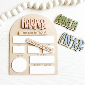 Interchangeable and reusable first/last day of school sign.  Features magnetic interchangeable names in your choice of color, velcro first/last day of school pieces and white dry erase areas to fill in milestones!