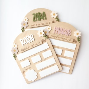 First/Last day of school sign with acrylic flowers and engraved butterflies. Features child's name in choice of acrylic color, and white areas to write milestones with a dry erase marker (not included).