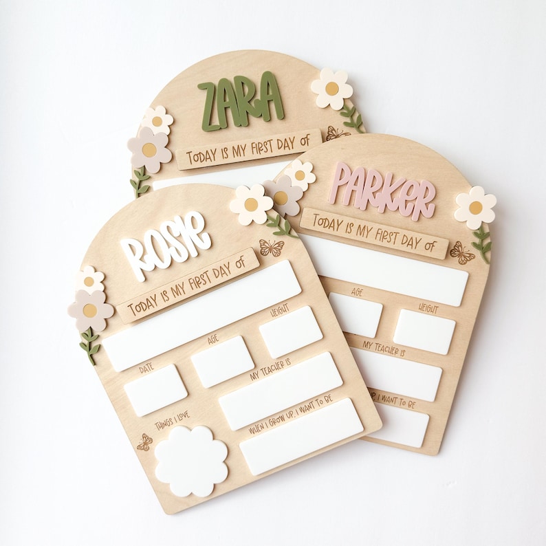 First/Last day of school sign with acrylic flowers and engraved butterflies. Features child's name in choice of acrylic color, and white areas to write milestones with a dry erase marker (not included).