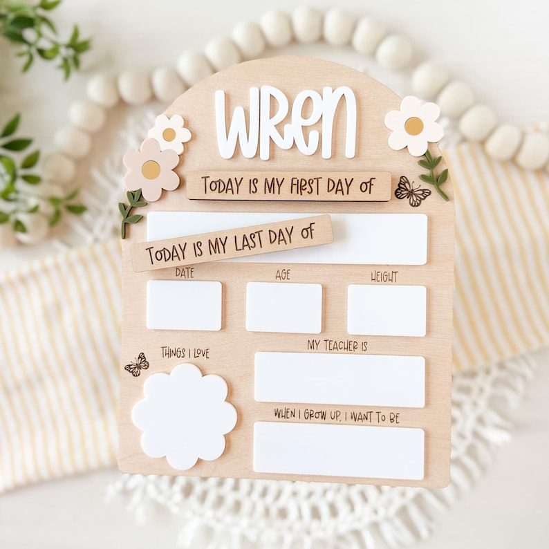 First/Last day of school sign with acrylic flowers and engraved butterflies. Features child's name in choice of acrylic color, and white areas to write milestones with a dry erase marker (not included).