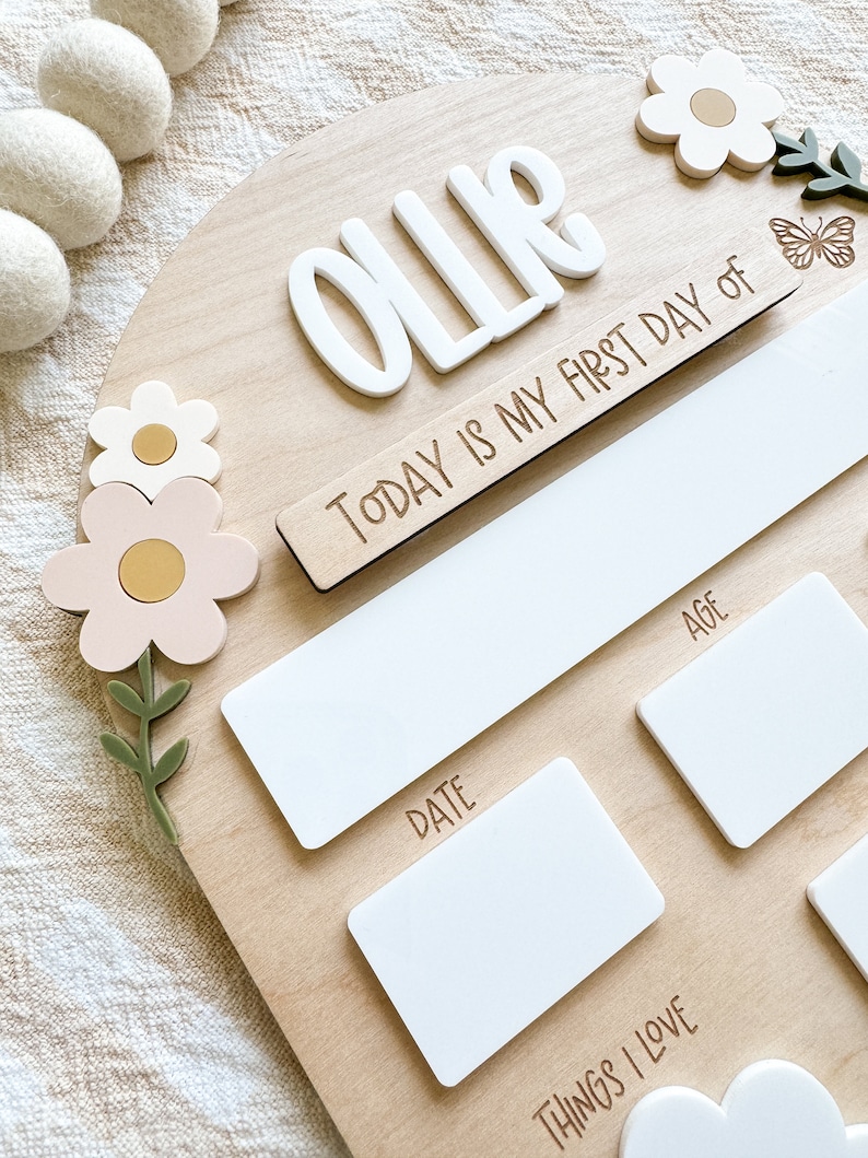 First/Last day of school sign with acrylic flowers and engraved butterflies. Features child's name in choice of acrylic color, and white areas to write milestones with a dry erase marker (not included).