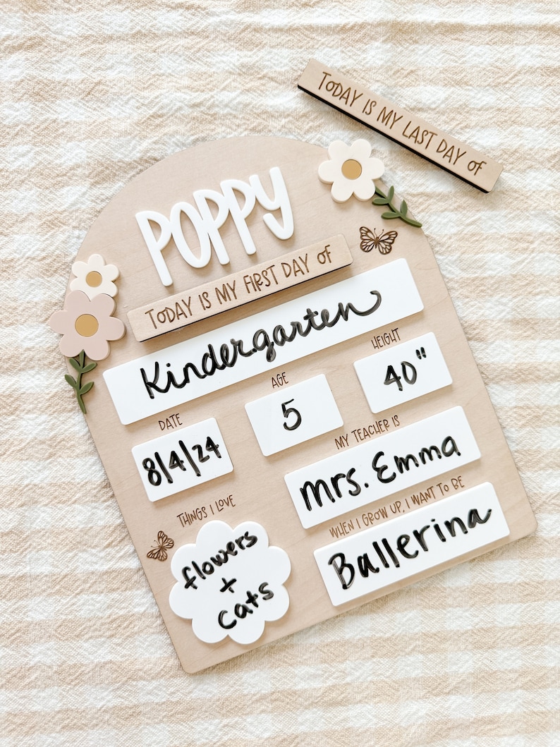 First/Last day of school sign with acrylic flowers and engraved butterflies. Features child's name in choice of acrylic color, and white areas to write milestones with a dry erase marker (not included).