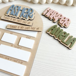 Interchangeable and reusable first/last day of school sign.  Features magnetic interchangeable names in your choice of color, velcro first/last day of school pieces and white dry erase areas to fill in milestones!