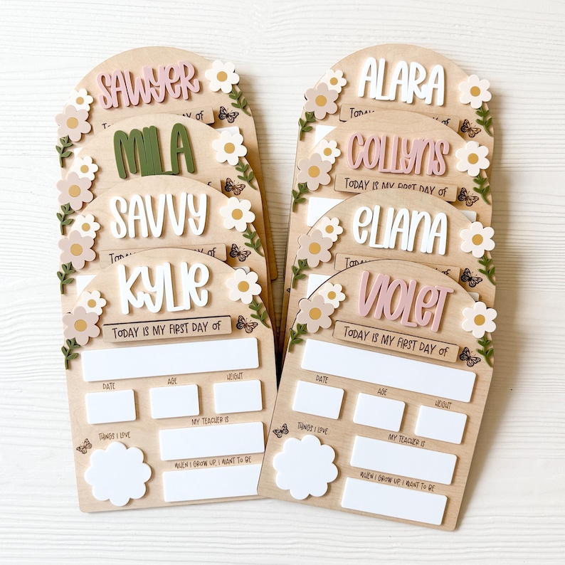First/Last day of school sign with acrylic flowers and engraved butterflies. Features child's name in choice of acrylic color, and white areas to write milestones with a dry erase marker (not included).