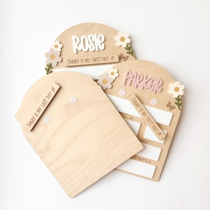 First/Last day of school sign with acrylic flowers and engraved butterflies. Features child's name in choice of acrylic color, and white areas to write milestones with a dry erase marker (not included).