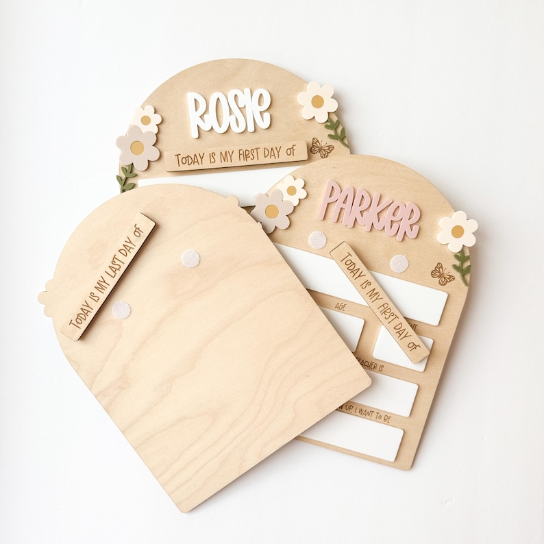 First/Last day of school sign with acrylic flowers and engraved butterflies. Features child's name in choice of acrylic color, and white areas to write milestones with a dry erase marker (not included).