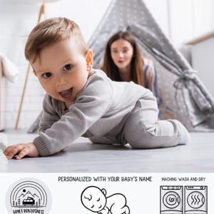 a baby crawling with the words Personalized With Your Baby's Name, Hand Designed, Family Run Business