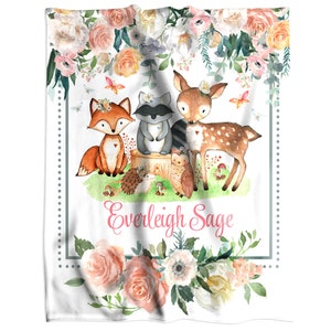 a personalized minky blanket with a picture of a fox, a raccoon, a deer and a hedgehog surrounded with beautiful flower in pink cream and peach