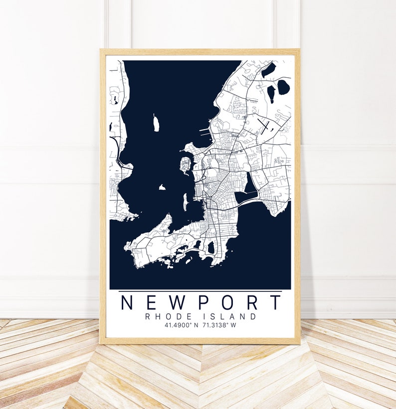 May include: A navy blue map print of Newport, Rhode Island, with white lines showing the streets and waterways. The text "NEWPORT" and "RHODE ISLAND" is printed in white at the bottom of the map, along with the coordinates "41.4900&deg; N 71.3138&deg; W".