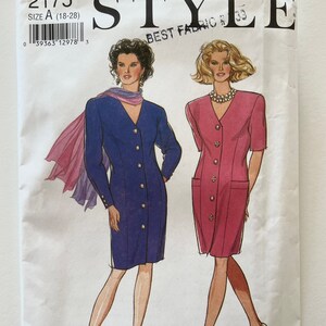 May include: A vintage sewing pattern titled "STYLE" with the number 2175. The pattern features illustrations of two women wearing dresses. The size is A (18-28). The words "BEST FABRIC" are also visible.