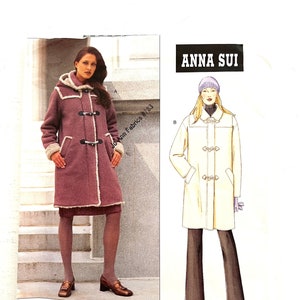 May include: Vogue Patterns sewing pattern #2484 for a long, hooded coat with toggle closures. The pattern is designed by Anna Sui and includes instructions for sizes L-XL.