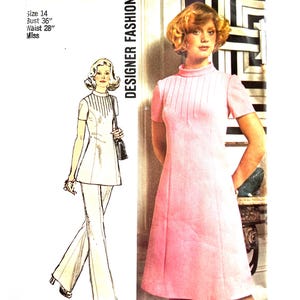 May include: Vintage Simplicity Designer Fashion sewing pattern. The pattern features a pink dress with short sleeves and a high neckline, and a matching illustration of a pantsuit. The pattern size is 14, with a 36-inch bust and a 28-inch waist.