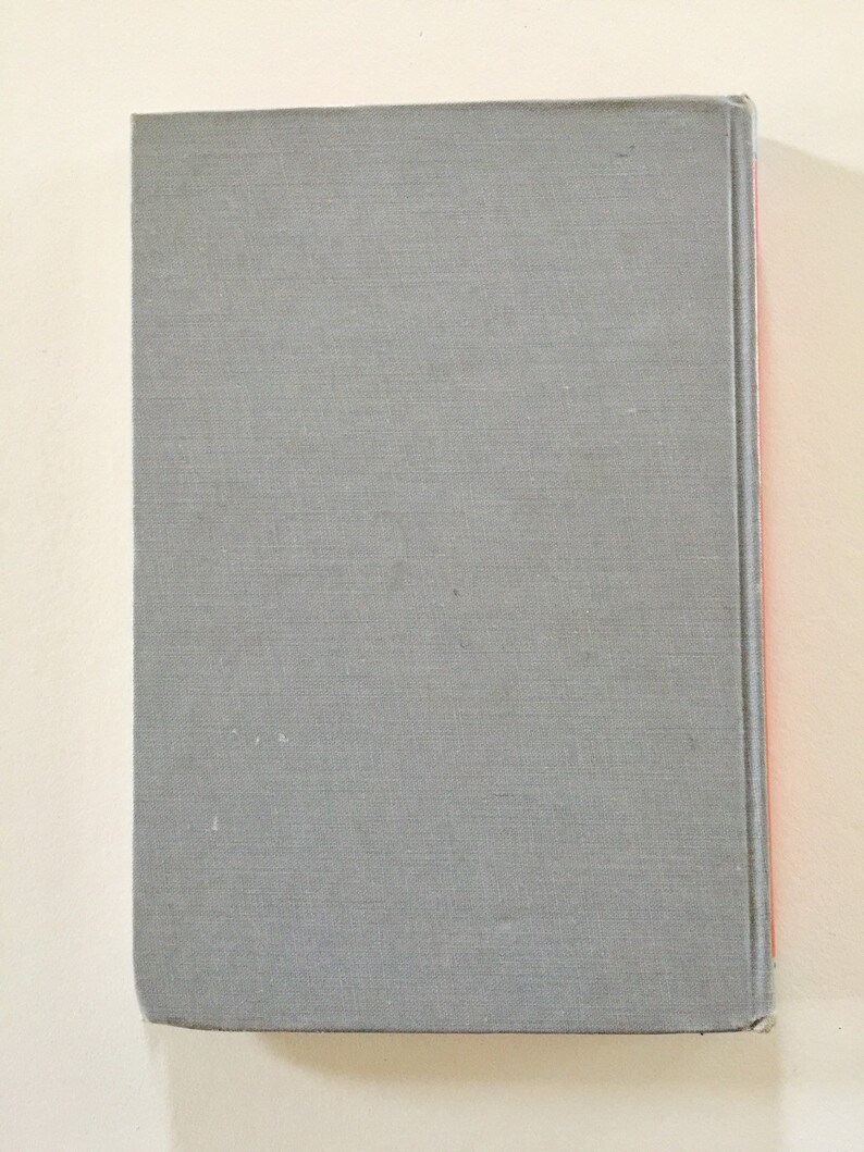 May include: A gray hardcover book with a red spine.