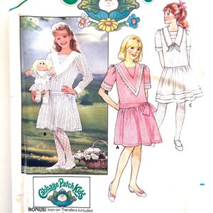 May include: A vintage Butterick sewing pattern for Cabbage Patch Kids outfits. The pattern features illustrations of girls in dresses, with the Cabbage Patch Kids logo and text. Includes bonus iron-on transfers. Size 7.
