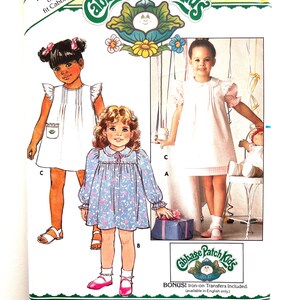 May include: A vintage Butterick sewing pattern for Cabbage Patch Kids outfits. The pattern features illustrations of children in dresses. The package is yellow and includes the text "FREE PATTERN" and "BONUS! Iron-on Transfers Included."