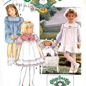 May include: Vintage Butterick sewing pattern for Cabbage Patch Kids outfits. The pattern features illustrations of children's dresses in various styles, with the Cabbage Patch Kids logo and text. Includes iron-on transfers.