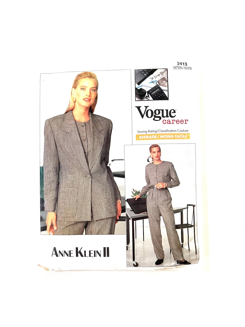 May include: A Vogue career sewing pattern for a gray suit jacket and pants. The pattern is by Anne Klein II and has a sewing rating of average/moins facile.