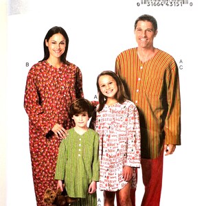 May include: A Butterick sewing pattern B5433 featuring a family wearing pajamas. The pattern includes a long red floral print nightgown, green striped pajamas, a white printed nightgown, and a red and yellow striped pajama top and red pants.