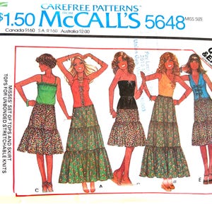 May include: A vintage McCall's sewing pattern for a set of tops and a skirt. The pattern number is 5648 and the size is small. The pattern is for misses and features a tiered skirt with floral print.
