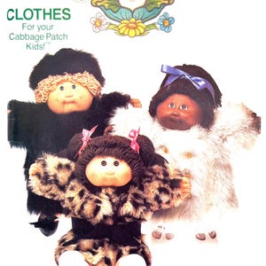 May include: A vintage Cabbage Patch Kids clothing pattern cover featuring three dolls in different outfits. The dolls have soft, round faces and are dressed in faux fur and animal print. The cover includes the text "CLOTHES For your Cabbage Patch Kids!"