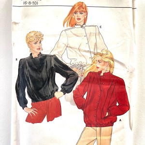 May include: A vintage Butterick sewing pattern, featuring illustrations of three different jacket styles. The pattern number is 4504, and the size range is (6-8-10). The jackets are shown in black, white, and red, with details like a stand-up collar and elastic waist.