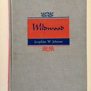 May include: A gray book with a red and blue title that reads "Wildwood" by Josephine W. Johnson.