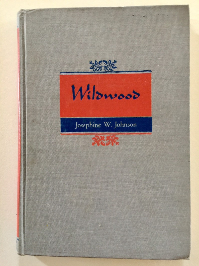 May include: A gray book with a red and blue title that reads "Wildwood" by Josephine W. Johnson.