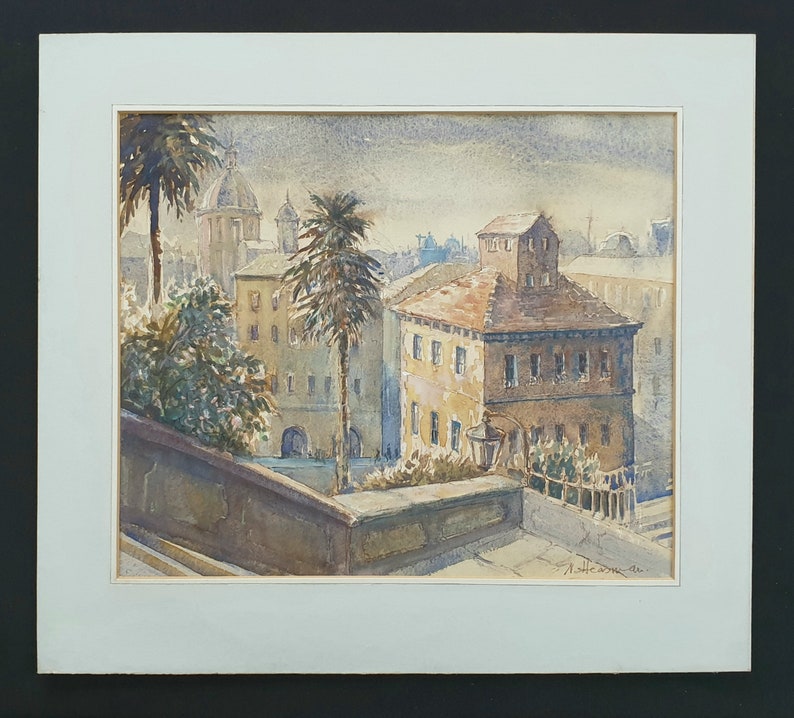 May include: Watercolor painting of a European cityscape with buildings, palm trees, and a domed structure in the background. The artwork is framed with a white mat and a black border. The painting is signed in the lower right corner.