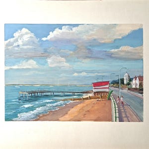May include: A watercolour painting depicting a coastal scene. A pier stretches into the turquoise sea under a sky of fluffy white clouds. A red and white building is on the shore, with a road and streetlights running alongside the beach.
