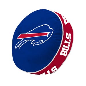 May include: A round blue throw pillow featuring a white and red Buffalo Bills logo on the front. The side panel is red with the word BILLS printed in white capital letters repeatedly around the circumference, separated by white piping trim.