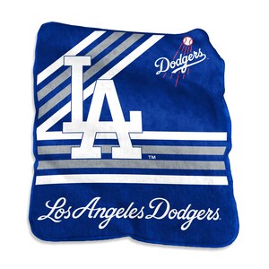 May include: A blue Los Angeles Dodgers blanket with the team's logo and name. The blanket features the letters "LA" in white, with silver and white stripes. The Dodgers logo and name are in white script.