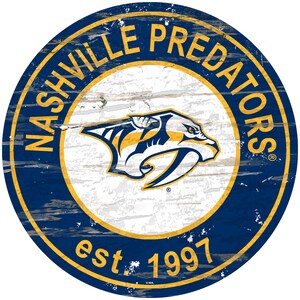 May include: A round, blue and gold sign with the words "Nashville Predators" and "est. 1997" on it. The sign features a stylized predator head logo in the center.