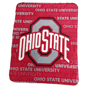 May include: A red and gray Ohio State University blanket. The blanket features the Ohio State logo in white with a gray and black outline. The background is red with the words "OHIO STATE UNIVERSITY" repeated.