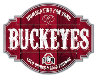 May include: A red and gray wooden sign with the text "Homegating Fan Zone" and "Buckeyes" in white. The sign also features the Ohio State University logo and the text "Cold Drinks & Good Friends".