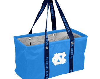 May include: A light blue rectangular tote bag with navy blue straps. The straps are printed with "TAR HEELS" in white. The bag features a white logo on the front and a gray interior lining. The bag has a zipper pocket.