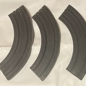 May include: Three black plastic curved track pieces for a slot car racing set.